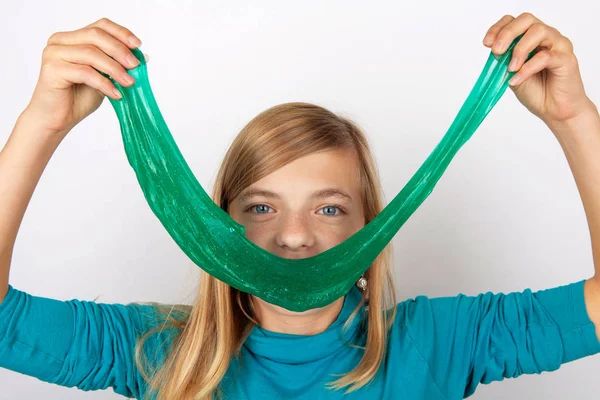 Funny girl forming a big smile with slime in front of her face