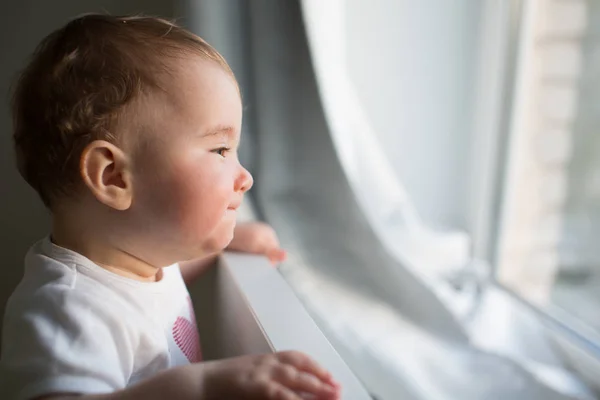 Happy and small child near the window — Stock Photo, Image