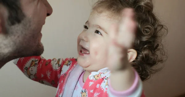 Small child smiles happily at a man and draws his hands to him — Stock Photo, Image