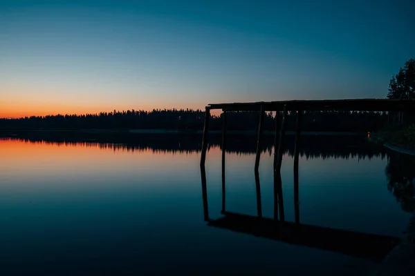 wooden bridge from which jump into the lake at night