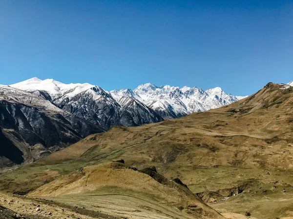 landscape of mountains and hills covered with snow against the sky