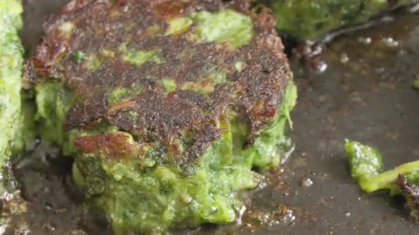 Vegetarian cutlets made from green vegetables fried in a pan — Stock Video