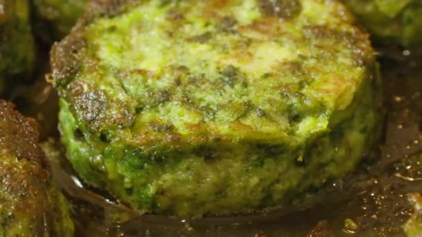 Vegetarian cutlets made from green vegetables fried in a pan — Stock Video