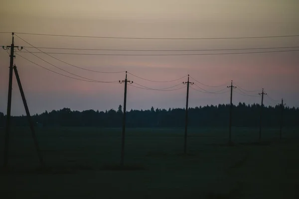 Electric support in the field in the evening — Stock Photo, Image