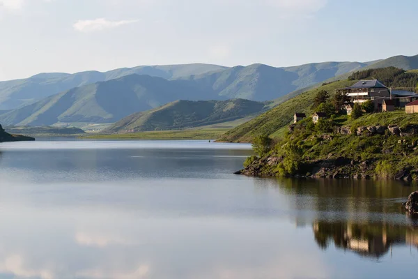 lake in the background of mountains in the daytime