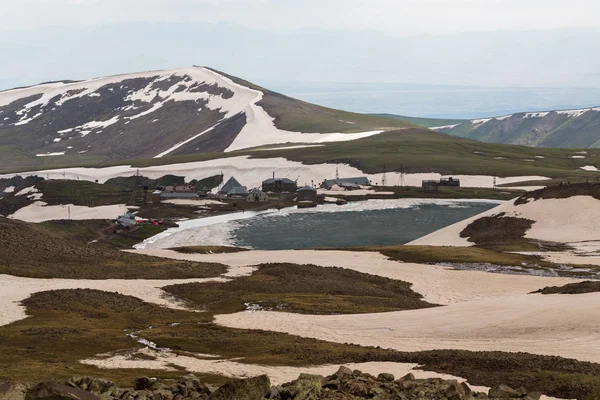 tourist base in the mountains near a small lake