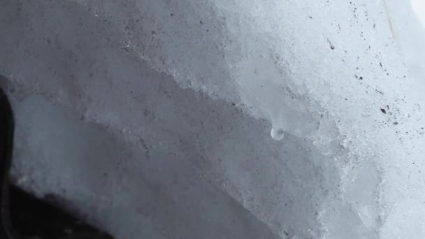 Snow melts and water drops drip from the old roof of the house — Stock Video