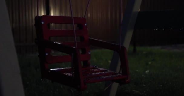 Empty swing for children in the evening — Stock Video