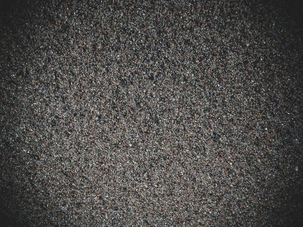 Small sand grains of sand top view dark designer background — Stock Photo, Image