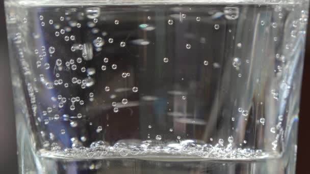 Clean sparkling water in a transparent glass beaker close up — Stock Video