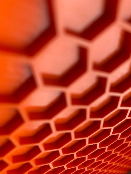 Textura de plástico naranja en forma de panales primer plano, fondo abstracto — Foto de Stock
