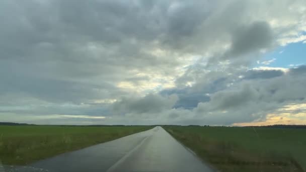 Подорожі на машині під час літнього дощу на заміській дорозі — стокове відео