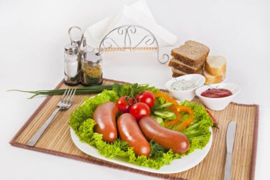 Domates, salatalık ve Yeşiller ile sosis haşlama. Siyah ya da beyaz ekmek ile servis. Mükemmel bir ek bir sıcak sos ve hardal var. Bu yemek yemek için güç ve neşe verir.