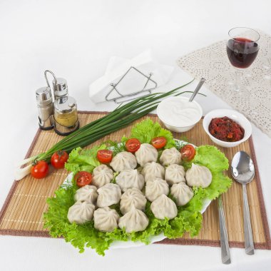 Yeşil domates ve soğan ile Kinkali. Soya sosu ve ekşi krema ile servis yapın. Kara biber ve hardal harika bir katkı olacak. Bir bardak kırmızı şarap tart ile güzel.