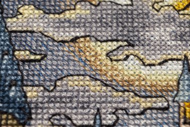 Kanaviçe işi. Makro fotoğrafçılık nakış siteleri. Netlik küçük bir blöf ile ateş. Tuval üzerinde parlak desenleri.