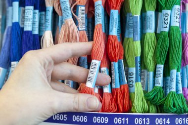 Tolyatti, Rusya, 09 Haziran 2018: Taşlar ile renkli mouline deposunda. Renk mouline konu bir el. Mulina konu nakış çapraz ve pürüzsüz için paleti. Önden görünüm.