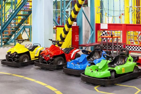 Children's attraction with colorful electric cars. Family holiday. Amusement park.
