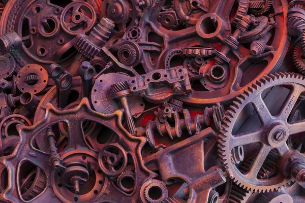 Steampunk background, machine parts, large gears and chains from machines and tractors. Old rusty machine parts. Springs, bearings, pistons, crankshafts, camshafts.