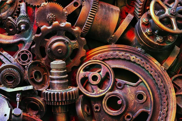 Steampunk background, machine parts, large gears and chains from machines and tractors. Old rusty machine parts. Springs, bearings, pistons, crankshafts, camshafts.