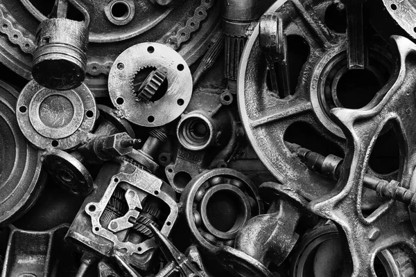 Steampunk background, machine parts, large gears and chains from machines and tractors. Old rusty machine and mechanical parts. Springs, bearings, pistons, crankshafts, camshafts.