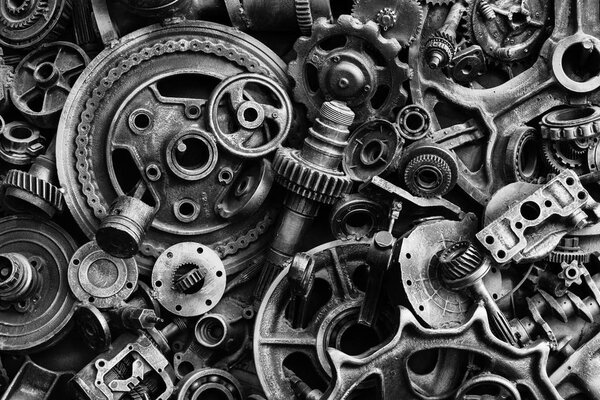 Steampunk texture, backgroung with mechanical parts, gear wheels, steam punk cogwheels, heap of auto parts, old rusty iron chains, springs, wheels, close up