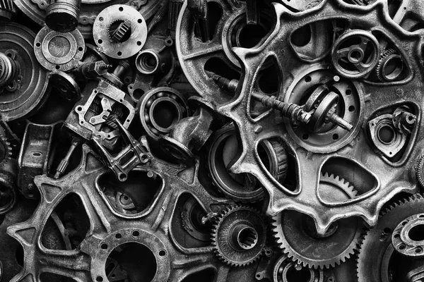 Steampunk texture, backgroung with mechanical parts, gear wheels, steam punk cogwheels, heap of auto parts, old rusty iron chains, springs, wheels, close up