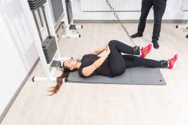 Kadın ayakları üzerinde kablo crossover makine spor salonunda egzersiz