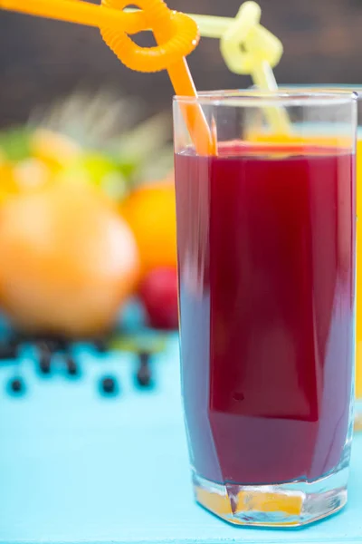 Tall glass of freshly squeezed fruit juice with blueberries and citrus rich in vitamin C for a healthy diet