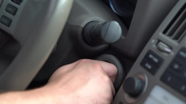 Hand of person switching on car ignition — Stock Video