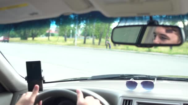 Man driving a car waiting at an intersection — Stock Video