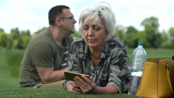 Vrouw met behulp van haar mobiele telefoon buiten — Stockvideo