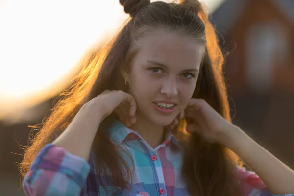 Happy Teenage Girl Looking Camera While Adjusting Brown Hair Blurred — Stock Photo, Image