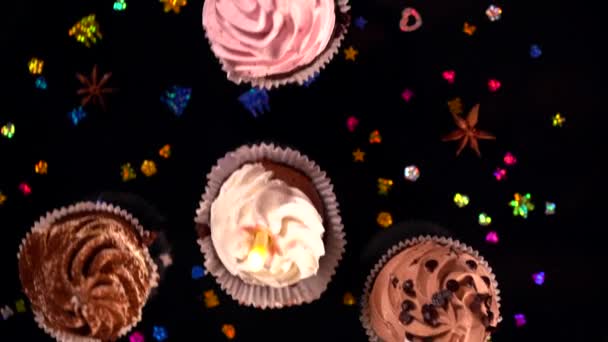 Fresh iced cupcakes with scattered dried spice — Stock Video