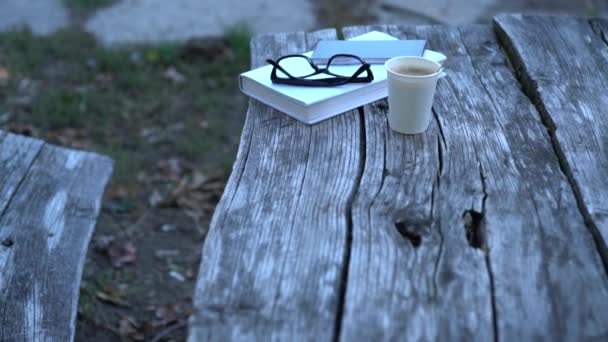 Livre, lunettes de lecture et café à emporter — Video