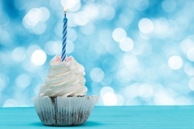 Cupcake mum parlak parti ışıkları ile mavi bir arka plan üzerinde kopya alanı bokeh karşı