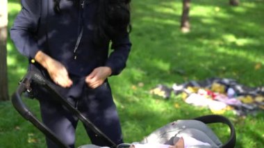 Genç anne ve bebeği arabasındaki bebek