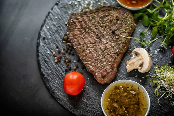 Portion of seasoned grilled steak with sprouts — Stock Photo, Image