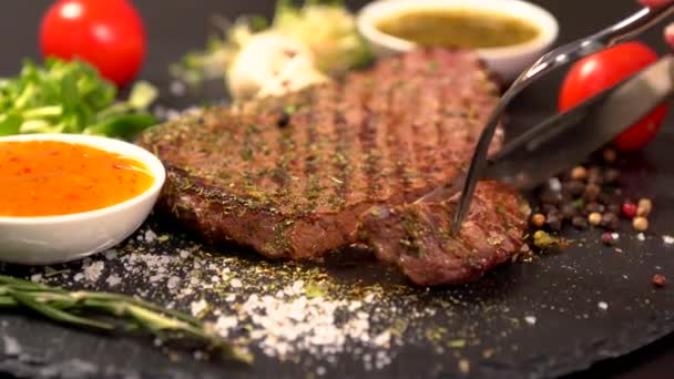 Person slicing a tender rump steak with a knife — Stock Video