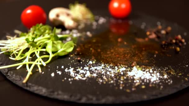 Portion of raw beef tossed onto a black board — Stock Video