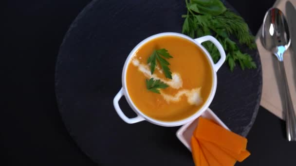 Revolving bowl of thick creamy butternut soup — Stock Video