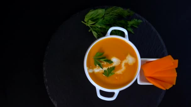 Serving of colorful tasty pumpkin soup in a bowl — Stock Video