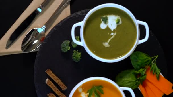 Spinning bowls of fresh pumpkin and broccoli soup — Stock Video