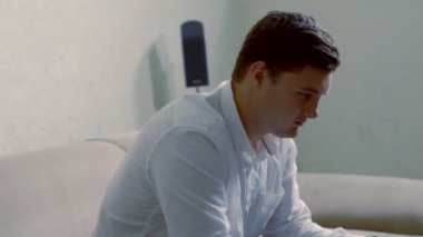 Evden dizüstü bilgisayarda çalışan genç adam