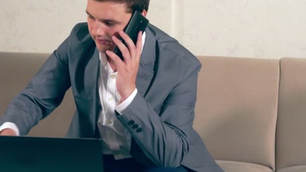 Businessman taking a call on his mobile phone — Stock Video