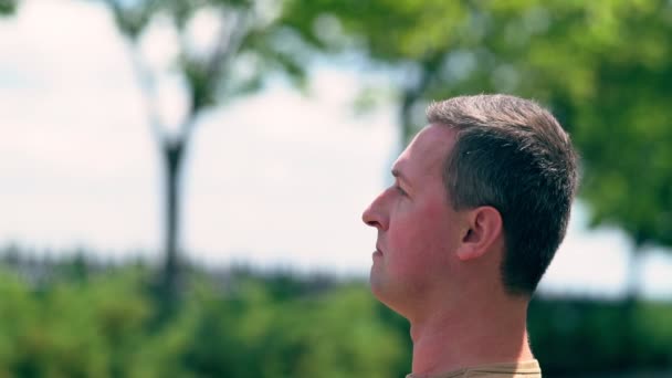 Man smoking and exhaling a puff of smoke — Stock Video