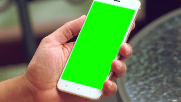 Man sitting at a table with his mobile phone — Stock Video