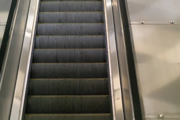 Primer plano en las pisadas de una escalera mecánica en movimiento — Foto de Stock