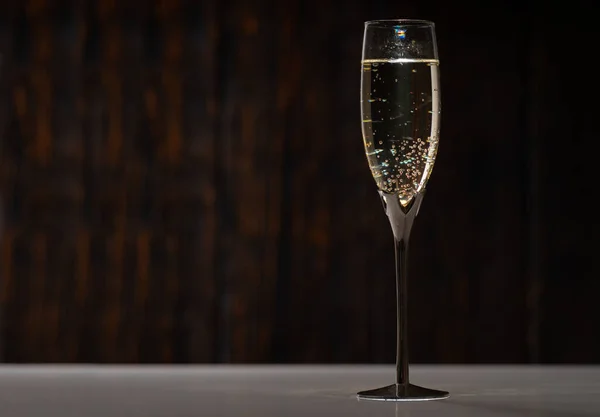 优雅的杯子或长笛 有气泡的香槟或起泡的葡萄酒放在旁边的桌子上 有复制的空间 — 图库照片