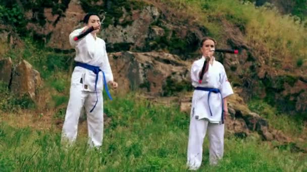 Women doing a synchronised display with nunchucks — Stock Video