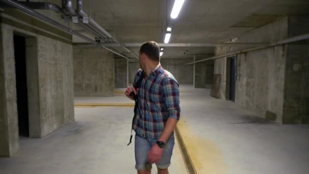 Man walking through a basement looking around — Stock Video